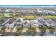 An elevated view of charming homes lining a neighborhood street, showing mature trees and meticulously kept front yards at 1003 Jack Nicklaus Ct, Kissimmee, FL 34747