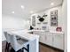 Stylish home wet bar featuring a countertop with seating, bar sink, and floating shelves at 1003 Jack Nicklaus Ct, Kissimmee, FL 34747