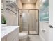 Updated bathroom features a glass enclosed shower, neutral tile, and modern vanity at 1003 Jack Nicklaus Ct, Kissimmee, FL 34747