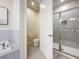 Bathroom showcasing a soaking tub, toilet, and walk-in shower with glass door at 1003 Jack Nicklaus Ct, Kissimmee, FL 34747