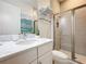 A bright bathroom with a marble vanity, a shower with a glass door, and modern decor at 1003 Jack Nicklaus Ct, Kissimmee, FL 34747