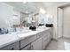 Bathroom featuring double vanity with white marble counters and sleek fixtures at 1003 Jack Nicklaus Ct, Kissimmee, FL 34747