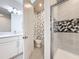 A stylish bathroom featuring a shower with glass doors, a separate toilet area, and modern fixtures at 1003 Jack Nicklaus Ct, Kissimmee, FL 34747