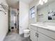 Clean bathroom with a marble countertop vanity, a window and access to the shower at 1003 Jack Nicklaus Ct, Kissimmee, FL 34747