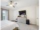 Bright bedroom with ceiling fan, natural light, view of balcony, and neutral tones at 1003 Jack Nicklaus Ct, Kissimmee, FL 34747