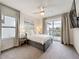 Cozy bedroom with neutral carpet, a ceiling fan, and access to a private balcony at 1003 Jack Nicklaus Ct, Kissimmee, FL 34747