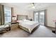 Cozy bedroom with ceiling fan, natural light from balcony door, and light-colored furnishings at 1003 Jack Nicklaus Ct, Kissimmee, FL 34747