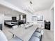 Expansive dining room with tile flooring, modern lighting fixture, and view of the kitchen area at 1003 Jack Nicklaus Ct, Kissimmee, FL 34747