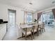 Bright dining room with tile flooring, modern chandelier, access to the bathroom and patio through sliding glass doors at 1003 Jack Nicklaus Ct, Kissimmee, FL 34747