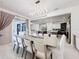 Open-concept dining room showcases tile flooring, modern lighting, and view of kitchen and living area at 1003 Jack Nicklaus Ct, Kissimmee, FL 34747
