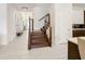 Inviting entryway featuring a modern staircase with wood and metal accents and bright tile flooring at 1003 Jack Nicklaus Ct, Kissimmee, FL 34747