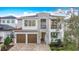 Stunning two-story home with stone accents, balcony, two-car garage, and a beautifully landscaped front yard at 1003 Jack Nicklaus Ct, Kissimmee, FL 34747