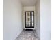 A welcoming entry with a modern front door and tiled floor, providing a stylish and functional entrance to the home at 1003 Jack Nicklaus Ct, Kissimmee, FL 34747