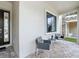 Inviting front porch with tiled floor and outdoor seating, creating a cozy and welcoming entrance at 1003 Jack Nicklaus Ct, Kissimmee, FL 34747