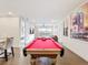Spacious game room featuring a billiards table, hardwood floors, and open floor plan at 1003 Jack Nicklaus Ct, Kissimmee, FL 34747