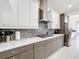 Well-equipped kitchen features modern appliances, a stainless steel range hood, and sleek countertops perfect for cooking at 1003 Jack Nicklaus Ct, Kissimmee, FL 34747