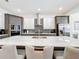 A modern kitchen with a large island, stainless steel appliances, and stylish gray and white cabinets at 1003 Jack Nicklaus Ct, Kissimmee, FL 34747
