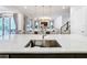 Stylish kitchen island with marble countertops, bar seating, and a view of the open-concept living space at 1003 Jack Nicklaus Ct, Kissimmee, FL 34747