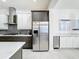 Modern kitchen with stainless steel appliances, dark and white cabinetry, and tile backsplash at 1003 Jack Nicklaus Ct, Kissimmee, FL 34747