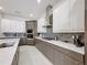 Modern kitchen featuring white and gray cabinetry, and stainless steel appliances creating a clean aesthetic at 1003 Jack Nicklaus Ct, Kissimmee, FL 34747