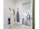 Bright laundry room with tile floors, including cleaning supplies and view into home's interior through doorway at 1003 Jack Nicklaus Ct, Kissimmee, FL 34747
