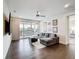 Spacious living room with a ceiling fan, access to a balcony, and a comfortable gray sectional at 1003 Jack Nicklaus Ct, Kissimmee, FL 34747