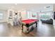 Bright open living space with a wet bar, pool table and sliding glass doors to a balcony at 1003 Jack Nicklaus Ct, Kissimmee, FL 34747