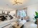 Bright living room with patio access and an open design to the kitchen and dining areas at 1003 Jack Nicklaus Ct, Kissimmee, FL 34747