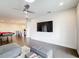 Spacious living room features a ceiling fan, hardwood floors, and access to the wet bar and pool table at 1003 Jack Nicklaus Ct, Kissimmee, FL 34747