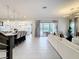 Expansive living room showcases an open floor plan, tile flooring, and seamless access to the outdoor area at 1003 Jack Nicklaus Ct, Kissimmee, FL 34747