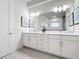 A bright Primary bathroom with double sinks, marble countertops, and stylish light fixtures at 1003 Jack Nicklaus Ct, Kissimmee, FL 34747