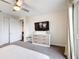 This modern bedroom includes a stylish dresser and a TV for relaxing evenings at 1003 Jack Nicklaus Ct, Kissimmee, FL 34747