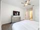 Bright main bedroom with a dresser and a view to the en-suite bathroom at 1003 Jack Nicklaus Ct, Kissimmee, FL 34747