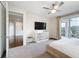 Relax in this main bedroom with a view to the balcony, bathroom, and staircase at 1003 Jack Nicklaus Ct, Kissimmee, FL 34747