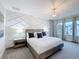 Stylish primary bedroom featuring decorative wall, chandelier, and neutral tones at 1003 Jack Nicklaus Ct, Kissimmee, FL 34747