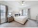 Serene main bedroom with large windows, soft carpeting, and tasteful decor at 1003 Jack Nicklaus Ct, Kissimmee, FL 34747