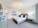 Elegant primary bedroom featuring decorative wall, stylish chandelier, and views to the connected primary bath at 1003 Jack Nicklaus Ct, Kissimmee, FL 34747