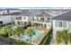 Aerial view of a backyard oasis featuring a sparkling pool, spa, and ample seating for relaxation and entertainment at 1003 Jack Nicklaus Ct, Kissimmee, FL 34747