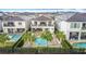 Stunning aerial view of a home with a luxurious pool, spa, and manicured backyard, perfect for outdoor living at 1003 Jack Nicklaus Ct, Kissimmee, FL 34747