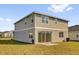 Expansive backyard featuring a covered patio and well-maintained lawn, ideal for outdoor activities and relaxation at 1209 Mattie Pointe Blvd, Auburndale, FL 33823