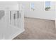 Upstairs hallway with neutral carpet, white trim, and lots of natural light from the three windows at 1209 Mattie Pointe Blvd, Auburndale, FL 33823