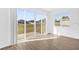 Bright and airy living room showcasing luxury vinyl plank flooring and sliding glass doors to the backyard at 1209 Mattie Pointe Blvd, Auburndale, FL 33823