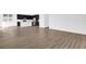 Spacious living room featuring new, wood-look flooring, neutral paint, and an open floor plan leading into the kitchen at 1209 Mattie Pointe Blvd, Auburndale, FL 33823