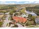 View of the clubhouse, pool, and pond in an attractive community with mature landscaping and proximity to nature at 1242 Butterfly Orchid Rd, Davenport, FL 33837