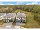 Aerial view of home featuring a tiled roof, professional landscaping and large green space at 1242 Butterfly Orchid Rd, Davenport, FL 33837