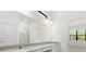 A bright bathroom featuring double sinks, a quartz countertop, and a large mirror at 1242 Butterfly Orchid Rd, Davenport, FL 33837