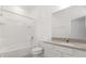 The bathroom features a vanity with a sink, a toilet, and a shower-tub combo at 1242 Butterfly Orchid Rd, Davenport, FL 33837