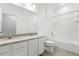 The bathroom features double vanities with sinks, a toilet, and a shower-tub combo at 1242 Butterfly Orchid Rd, Davenport, FL 33837