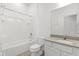 Clean bathroom with tub and shower combo, tiled floor, and modern sink at 1242 Butterfly Orchid Rd, Davenport, FL 33837
