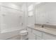Bathroom with a bathtub, shower, granite vanity, and a window at 1242 Butterfly Orchid Rd, Davenport, FL 33837